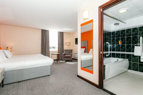 Premium bedding, desk, laptop workspace, blackout drapes