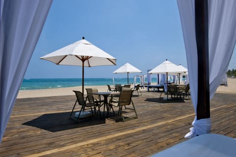 On the beach, white sand, sun loungers, beach umbrellas