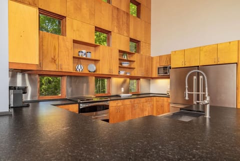Kitchen with double ovens, double refrigerators, dishwasher and large sink