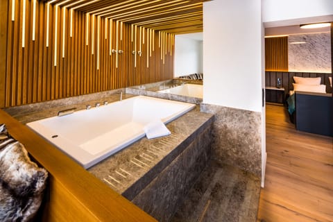 Premium Suite, Bathtub | Living area | 32-inch Smart TV with cable channels, Netflix, streaming services