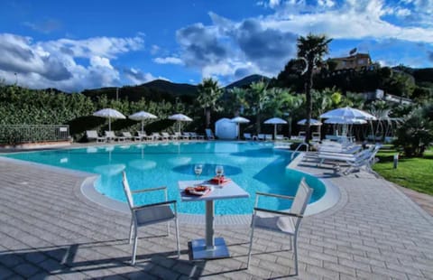 Seasonal outdoor pool, open 9:00 AM to 6:00 PM, pool umbrellas