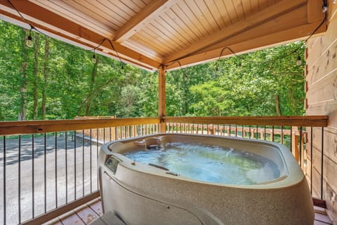 Relax in the bubbling hot tub with serene wooded views, the perfect end to your mountain getaway.