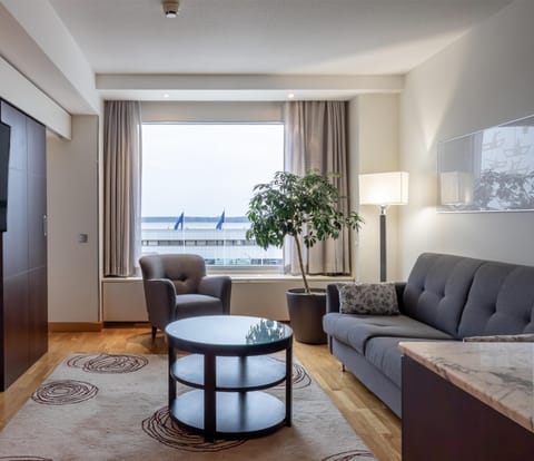 Junior Suite, 1 King Bed, Partial Sea View | Living area | TV