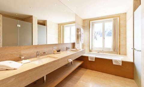 Deluxe Suite | Bathroom | Designer toiletries, hair dryer, bathrobes, slippers