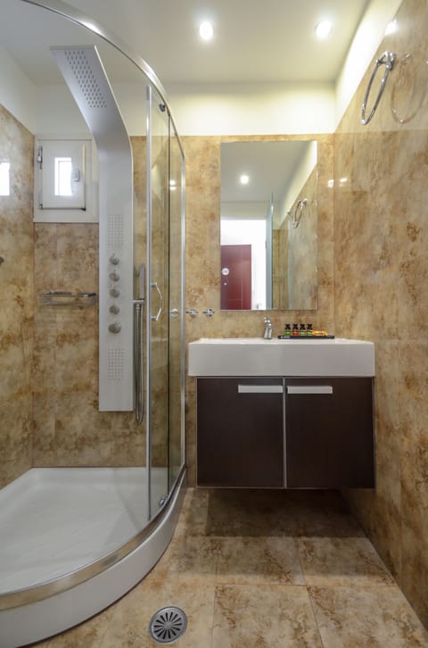 Shower, designer toiletries, hair dryer, slippers