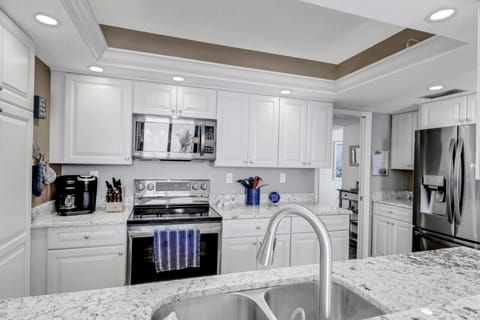 Fully stocked kitchen with granite counters and a Keurig Duo coffee pot.