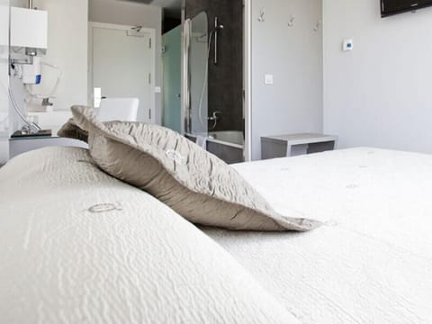 Premium bedding, down comforters, memory foam beds, minibar