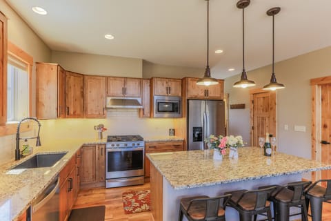 Kitchen with stainless steel appliances, and a gas stove