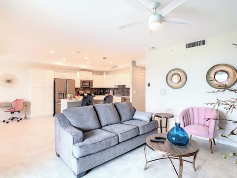 Open-concept living area with stylish seating and kitchen