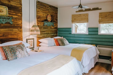 Two queen beds in a cozy Hill Country cabin, steps from downtown Wimberley.