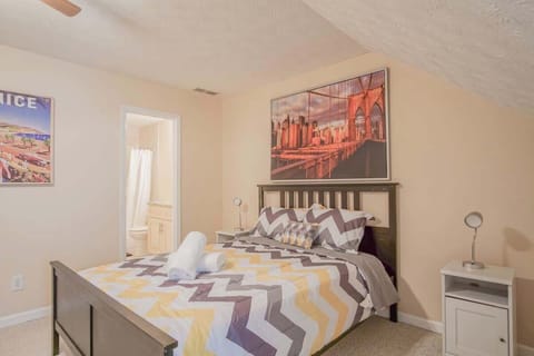 Queen bed with fresh linens and towels