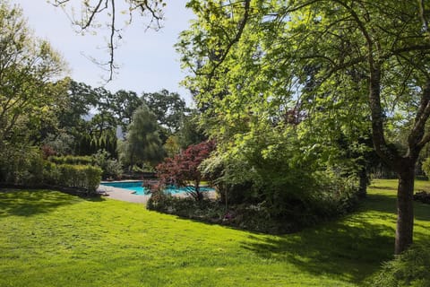 View of backyard and the pool entering from driveway gate