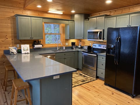 Well stocked kitchen with new quartz countertops and new appliances 