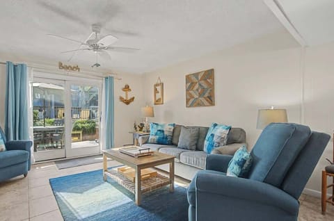 Relax in your beach-themed living room where coastal blues and sandy tones create the perfect seaside escape indoors.