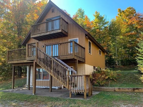 Charming Lodge Exterior: Enjoy stunning views and fresh air from the spacious upper deck!