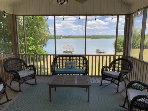 Screened in porch with lighting, ceiling fan,  and large TV 