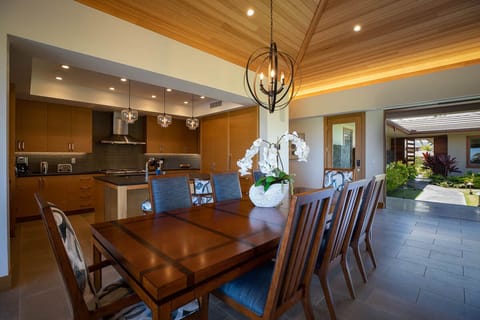 Share memorable meals beneath glowing pendant lights and a dramatic wood ceiling, just steps from the chef's kitchen.