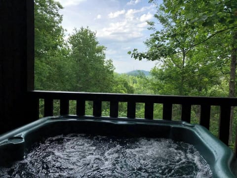 Panoramic mountain views peek through the dense greenery, creating a peaceful, secluded feel.