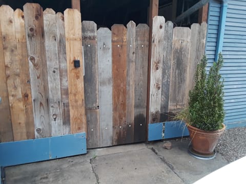 Gate with lock to the patio that leads to the front door.