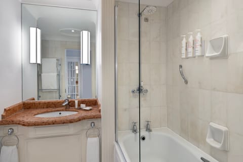 Combined shower/tub, designer toiletries, hair dryer, towels