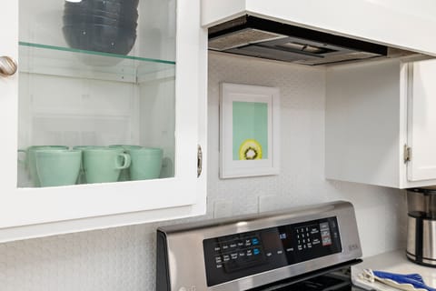 The Kitchen has stainless steel appliances and bright, white cabinets.