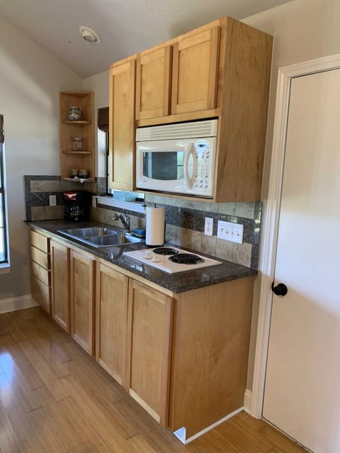 The country kitchen here includes a full-sized fridge and a stove top, however, there is no oven in the cabin. However, there is a charcoal grill outside!