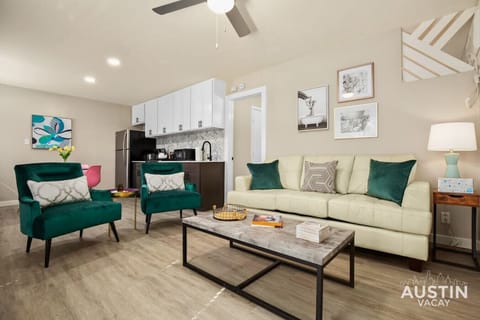 Open concept living room and kitchen with sleeper sofa and smart TV