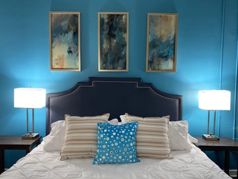 Comfortable King-size bed with device charging stations on both sides. 