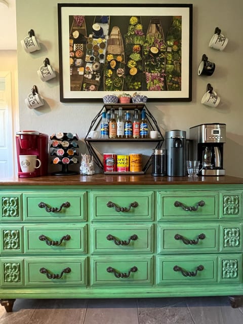 Drip-pot, Keurig, & a Nespresso machine along with assorted syrups and creamers.