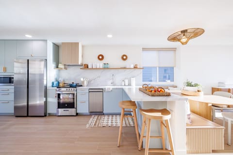 A beautifully updated kitchen showcasing custom cabinetry and custom countertops.