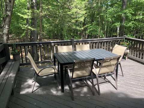 Large deck with patio table and seating for six.
