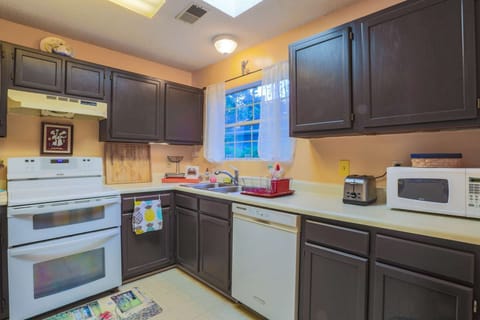 The kitchen features a double oven, dishwasher, refrigerator, microwave & toaster.