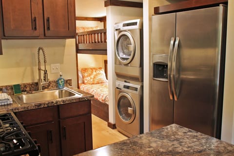 Kitchen Stocked With Towels, Coffee Machine, Dishes, and Soap