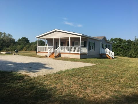 Covered porch entrance with Oaks Smart Lock. Fire pit and Weber Grill. 