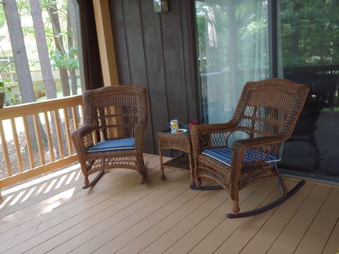 Covered porch has room for relaxing, water view, and table seating for 8 

