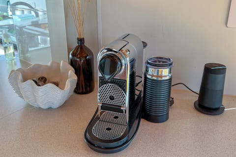 Nespresso pod machine, milk throther, and the Bose bluetooth sound speaker