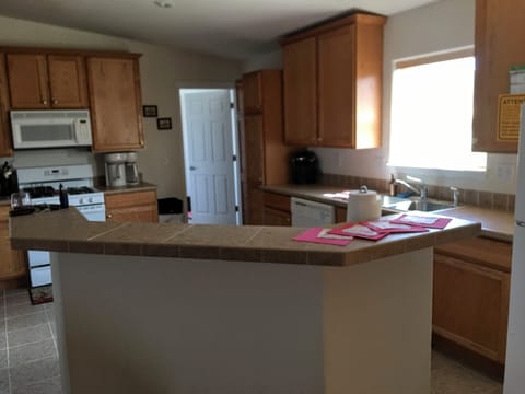 Large well equipped kitchen with vaulted ceilings and large workstation island.