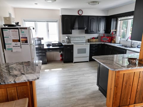 KITCHEN: ELECTRIC STOVE, WATER COOLER, COFFEE MAKER, WI-FI PRINTER