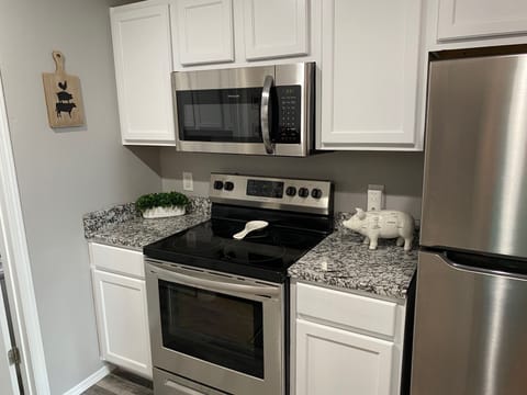 Newly remodeled kitchen has full size appliances and granite countertops