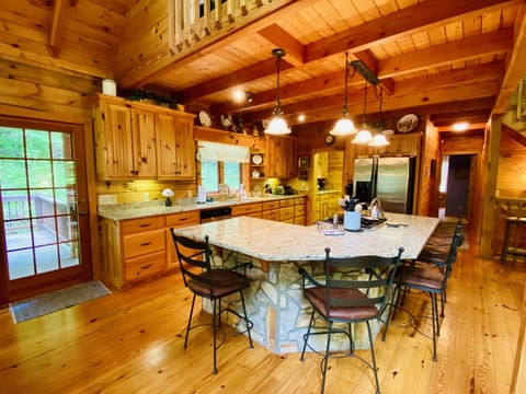 Kitchen with large island including 4 stools