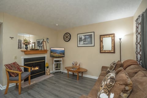 Settle into this welcoming living area where a cozy fireplace creates the perfect ambiance for your mountain getaway. Sink into the plush sofa with your favorite book or gather with loved ones for memorable evenings.