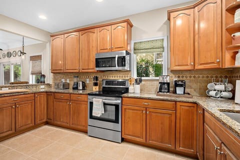 Kitchen stocked with Kuerig, coffee pot, hot water kettle, toaster, and more!