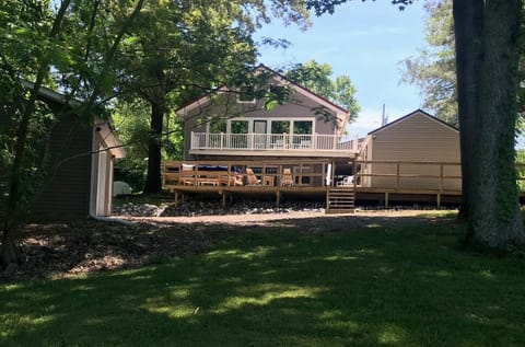 Back of the home facing large private yard 