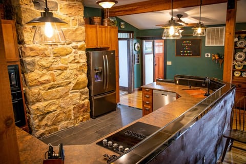 153 year old river rock chimney in kitchen that connects to kids' room.