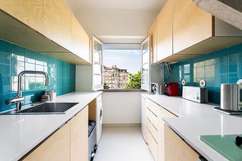 Fully equipped kitchen with views of the neighborhood.
