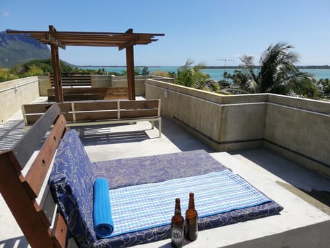 Chill out on the giant sunbeds with stunning sea views on the shared access roof