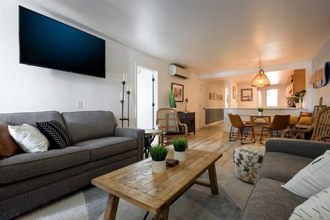 Relax in our comfy living room, flowing seamlessly into a modern kitchen, perfect for gathering!