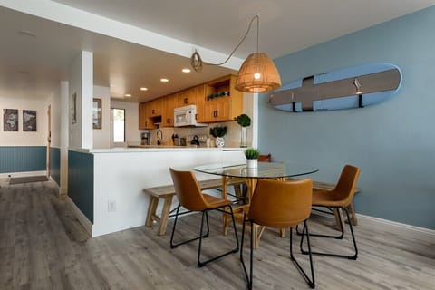 Dine in style! Enjoy meals in our chic dining area with modern finishes, connecting to a full kitchen.