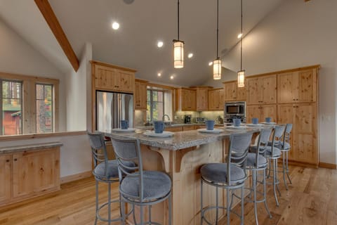 - Spacious kitchen with wood cabinetry  
- Stainless appliances and stone counters  
- Tahoe cabin rental with modern amenities