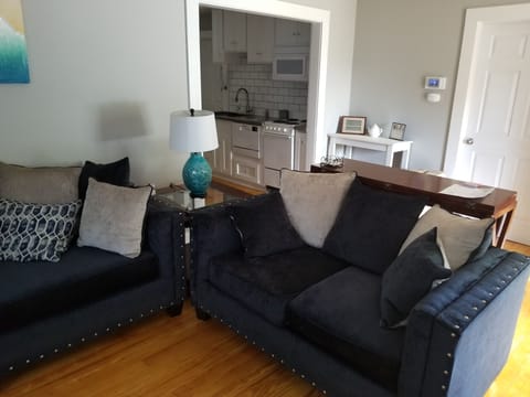Comfortable sofa & loveseat in living room area. 